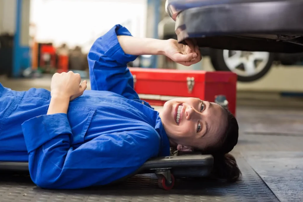 A picture of a mechanic working on a car. This image adds a professional and trustworthy element to the advice about getting repairs done by an expert.